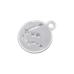 Macro shot of silver zodiac pendant with sparkling crystals on a plain white background