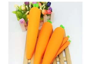 Multiple sizes of silicone carrot pencil cases with green leaf zipper pulls on display