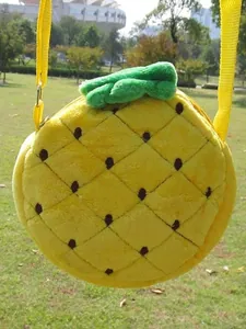 Plush pineapple crossbody bag for kids featuring yellow fur and green leaf decor