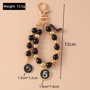 Detailed size and weight specs for the black and gold beaded keychain with number 5 charm