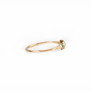 Side view of square opal engagement ring in gold with small diamonds on the band