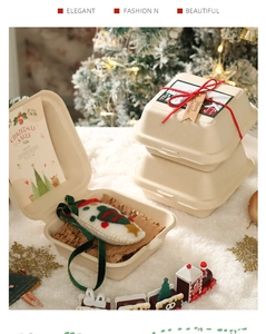 Detail of eco-friendly Christmas pulp gift box with festive snowman and red ribbon decor