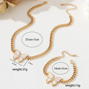 Detailed view of golden butterfly necklace and bracelet set with size measurements