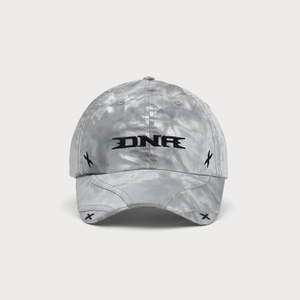 Detail of embroidered DNR logo and cross stitching on marble tie-dye baseball cap