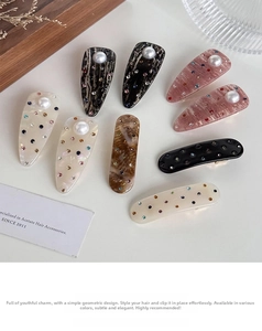Detailed shot of acetate hair clips with inlaid pearls and colorful rhinestones