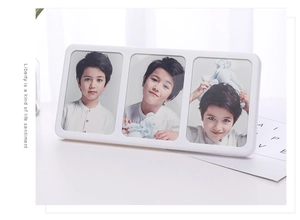 Detailed side view of a white triple folding picture frame with three vertical photo slots