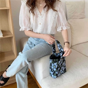 Blue floral jacquard fabric tote bag styled with lace top and blue jeans outfit