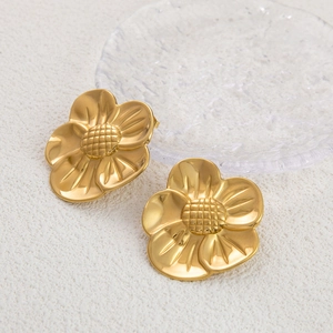 Elegant 18K gold plated titanium steel flower stud earrings for women on white surface