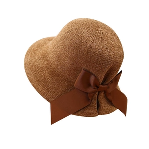 Caramel brown women's fisherman hat featuring a large elegant side bow on a white background