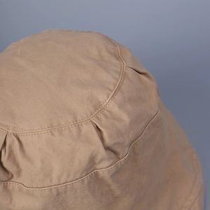 Detailed close-up of khaki cotton sun hat featuring reinforced stitching on the crown