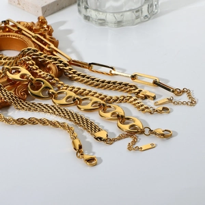 Close-up of 18K gold plated stainless steel curb and snake chain bracelet layering