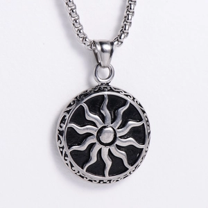 Detailed close-up of retro sun totem pendant with vintage black finish on square pearl chain