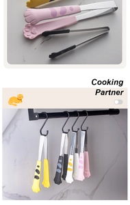 Detailed close-up of cat paw silicone food tongs in yellow, black, and pink colors