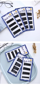 Bulk packs of black metal bob pins with ball tips on blue cards for professional hairstyling