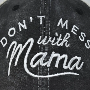 Detail of black washed cotton baseball cap featuring white 3D embroidery text