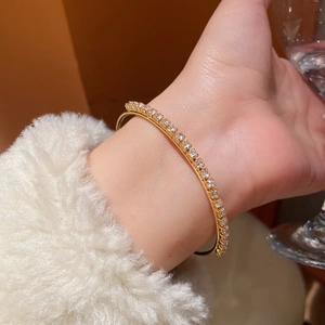 Close-up of a delicate 18K gold-plated tennis bracelet with sparkling zircon stones
