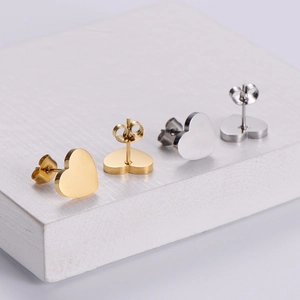 Minimalist heart-shaped stud earring set in polished gold and silver metallic finishes