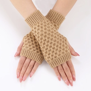 Macro detail of beige knit fingerless gloves with elegant diamond weave pattern