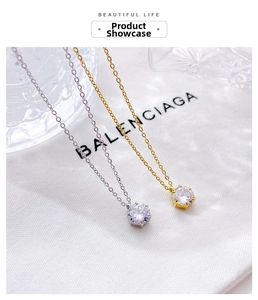 Macro shot of six-claw set diamond pendant necklaces in silver and gold finishes