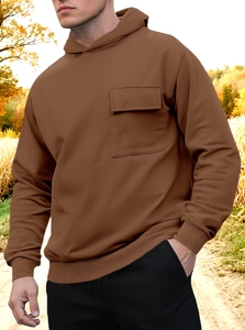Brown hooded sweatshirt featuring a front flap pocket and ribbed cuffs in autumn forest