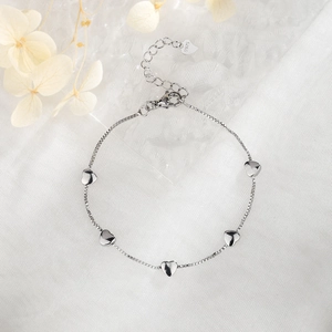 Detail showing five silver heart pendants on a delicate S925 sterling silver chain