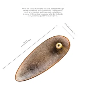 Bronze incense holder with hammered texture, measuring 14cm long and 5cm wide