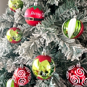 Close-up of assorted red and green Christmas ball ornaments with Merry Christmas lettering