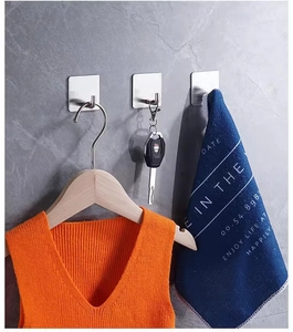 Strong self-adhesive stainless steel hook holding a coat and keys on a marble wall