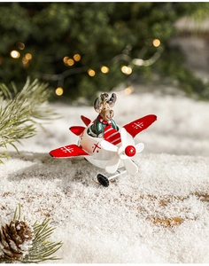 Detail showing a metal reindeer pilot plane ornament on artificial snow with bokeh background