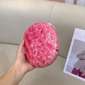 Detail of pink marble pattern oval clutch with artistic watercolor texture and white lines