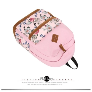 Detail view of the pink floral canvas backpack with durable stitching and leather accents