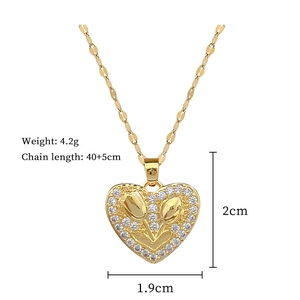 Macro shot of gold tulip heart pendant with crystals including size and weight specs
