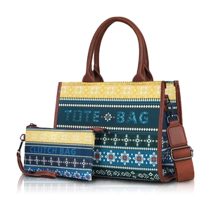 Detail of tribal print tote bag set featuring large tote and matching clutch with leather straps