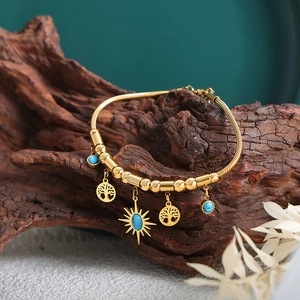 Bracciale snake in acciaio titanio dorato con ciondoli sole turchese e albero della vita