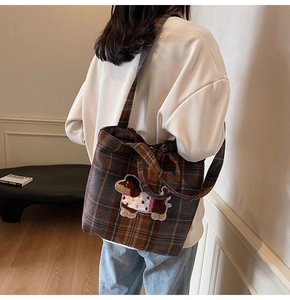 Detail of cute dog embroidery patch on brown plaid wool tote bag for women
