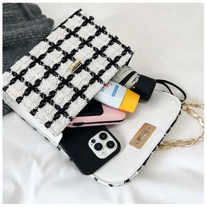 Interior view of checkered tweed flap bag showing spacious capacity for daily essentials