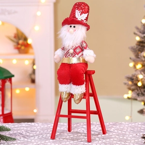 Detailed view of sitting Santa doll with red sequins and gold belt on holiday ladder
