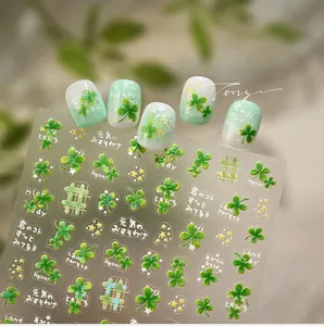 Detailed view of forest-style clover nail stickers with stars and Japanese text