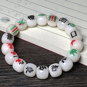 Detailed view of Mahjong-themed white jade bodhi root beads with colorful carvings
