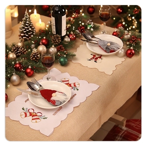 Christmas table setting with embroidered placemats and gnome silverware holders