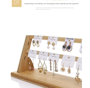 Macro view of double-tier bamboo earring display stand with various jewelry cards