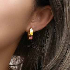 Macro shot of 18K gold plated hoop earrings with colorful dripping oil heart patterns