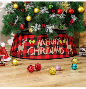 Detail of red and black buffalo plaid Christmas tree collar with gold Merry Christmas print