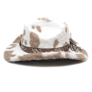 Detail of cow print western cowboy hat with plush texture, woven band, and metal rivets