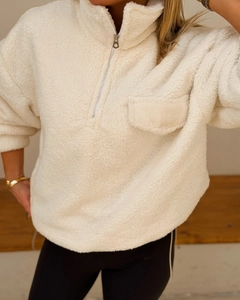 Detail of off-white polar fleece quarter-zip sweatshirt with chest pocket and stand collar