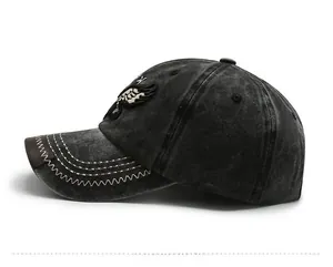 Detail showing vintage eagle embroidery and white contrast stitching on washed denim cap