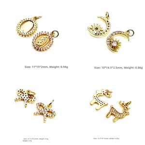 Detailed view of micro-pave zircon gold charms including moon star and butterfly motifs