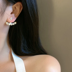 Close-up of sparkling rhinestone mesh earrings with detachable curved crystal pendants