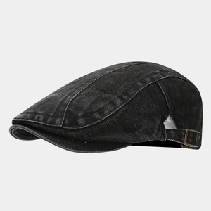 Macro detail of washed denim beret featuring a vintage bronze metal adjustable buckle