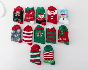 Flat lay of colorful Christmas fuzzy socks with festive patterns and soft coral fleece texture